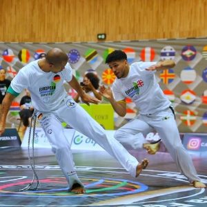 Two men fighting wearing Capoeira uniform
