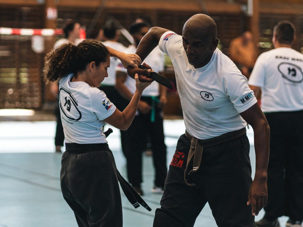 A men and women practicing Krav Maga wearing Krav Maga uniform