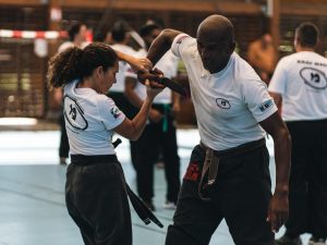 A men and women practicing Krav Maga wearing Krav Maga uniform